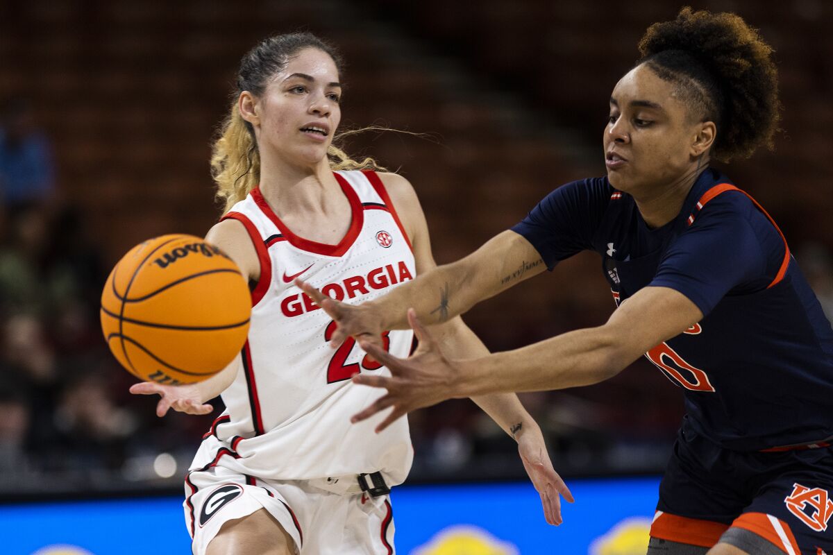 Georgia's Alisha Lewis (23) passes the ball past Auburn's Sydney Shaw (10) during the first half of an NCAA college basketball game in the Southeastern Conference women's tournament in Greenville, S.C., Thursday, March 2, 2023. (AP Photo/Mic Smith)