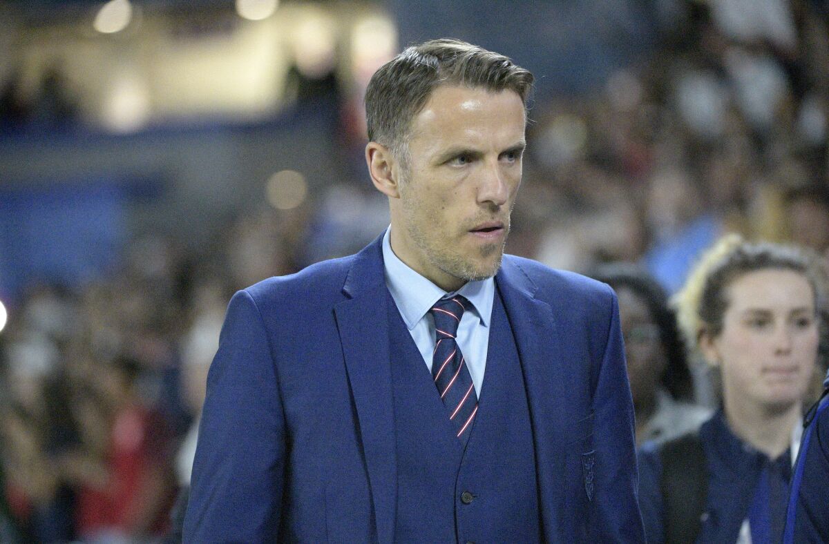 FILE - In this file photo dated Wednesday, March 7, 2018, England head coach Phil Neville walks onto the field before a SheBelieves Cup women's soccer match against the United States, in Orlando, USA. Neville will step down from coaching the England women's team when his contract expires next year, it is announced Friday April 24, 2020, missing out on leading the country at the rescheduled European Championship in 2022. (AP Photo/Phelan M. Ebenhack, FILE)