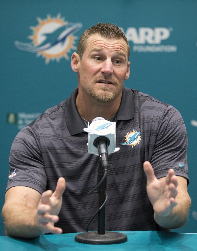 Former Miami Dolphins tight ends coach Dan Campbell gestures as he speaks during a news conference after being promoted to interim head coach, Monday, Oct. 5, 2015 in Davie, Fla. Joe Philbin has been fired four games into his fourth season as coach of the Dolphins, and one day after a flop on an international stage that helped to seal his fate. (AP Photo/Wilfredo Lee)