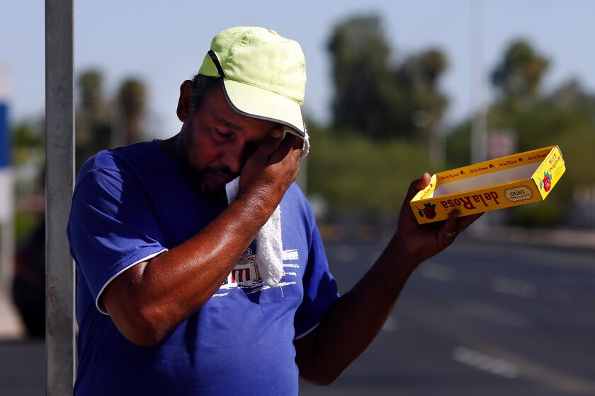 Asylum seeker Oswaldo Ortiz-Luna sells candy at a busy intersection in Mexicali, Mexico.
