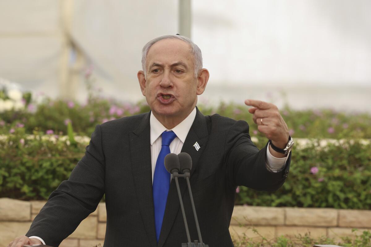 Israeli Prime Minister Benjamin Netanyahu speaks during a ceremony at the Nahalat Yitshak Cemetery in Tel Aviv.
