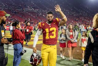 USC quarterback Caleb Williams waves to fans while leaving the field after the Trojans' 52-42 loss to Washington
