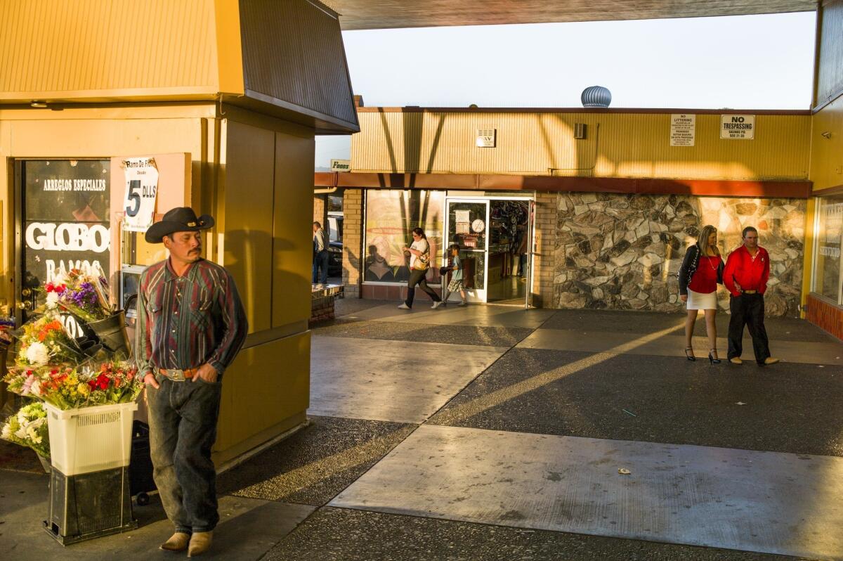 Shoppers and residents walk in the traditionally Latino and less-affluent east side of Salinas. An elementary school in that part of town has been named for controversial 19th century Mexican figure Tiburcio Vasquez, causing an uproar elsewhere in the city.