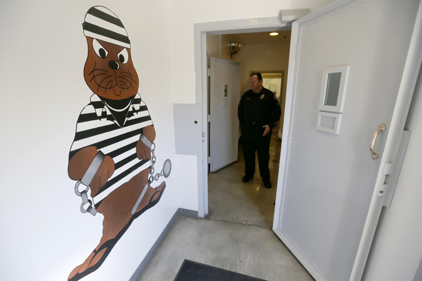Sgt. Steve Bowles shows off a room where "pay-to-stay" inmates can watch television, socialize and play games at the Seal Beach Detention Center. Small city jails — at least 26 of them in Los Angeles and Orange counties — are opening their doors to defendants who can afford the option.