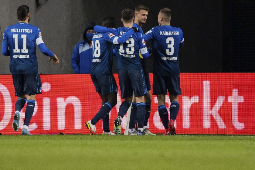 Hoffenheim's Stefan Posch, second right, celebrates scoring the first goal of the game during the German Bundesliga soccer match between 1. FC Cologne and TSG 1899 Hoffenheim at RheinEnergieStadion, Cologne, Germany, Sunday, March 6, 2022. (Rolf Vennenbernd/dpa via AP)