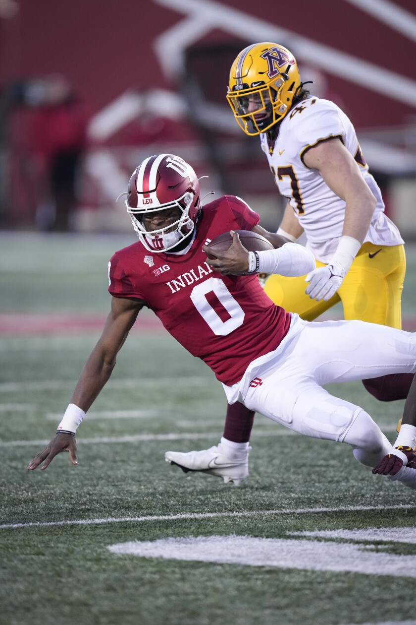 Indiana quarterback Donaven McCulley (0) is tackled in front of Minnesota linebacker Jack Gibbens (47) in the second half during an NCAA college football game in Bloomington, Ind., Saturday, Nov. 20, 2021. (AP Photo/AJ Mast)