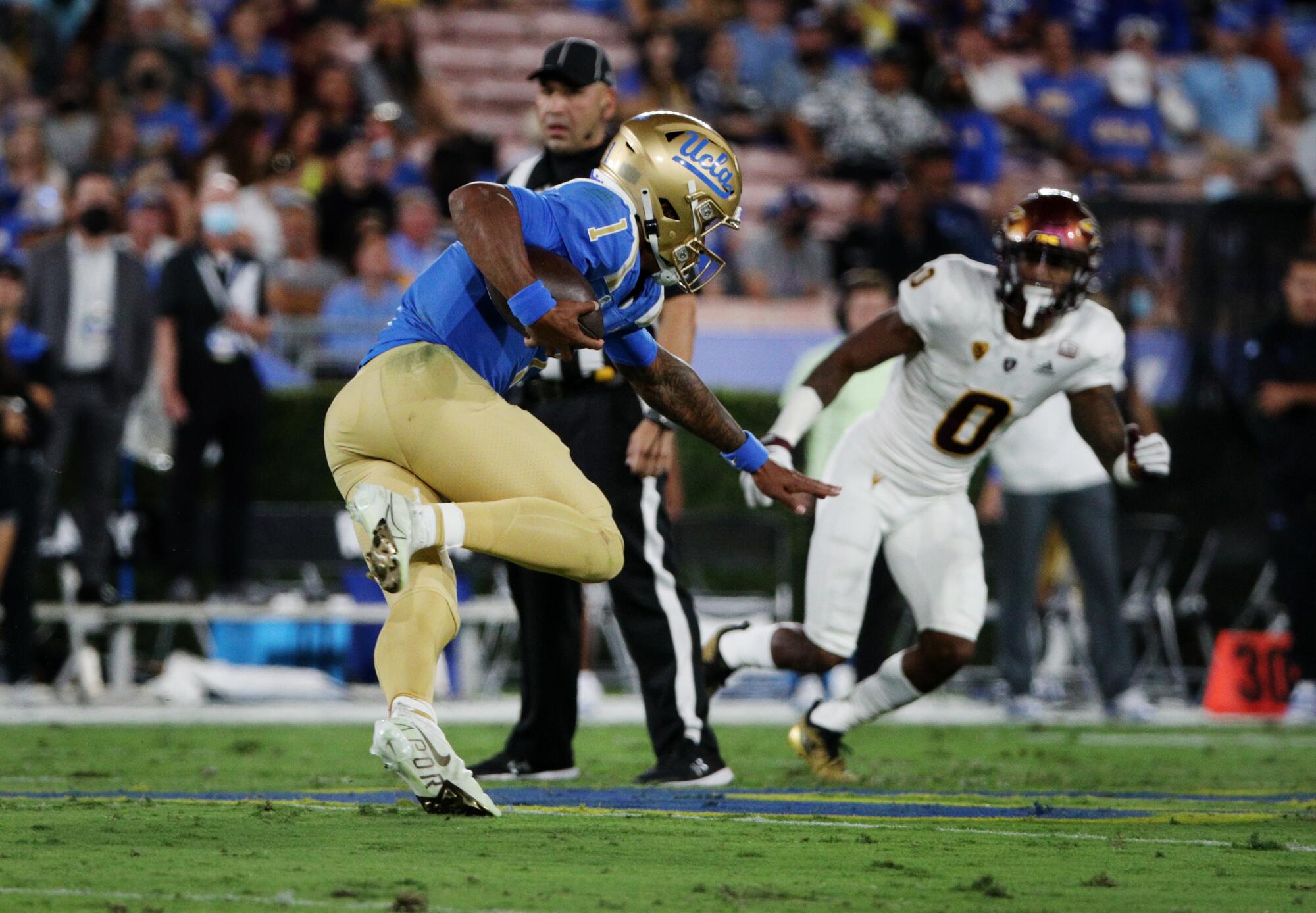 UCLA quarterback Dorian Thompson-Robinson scrambles with the ball against Arizona State.