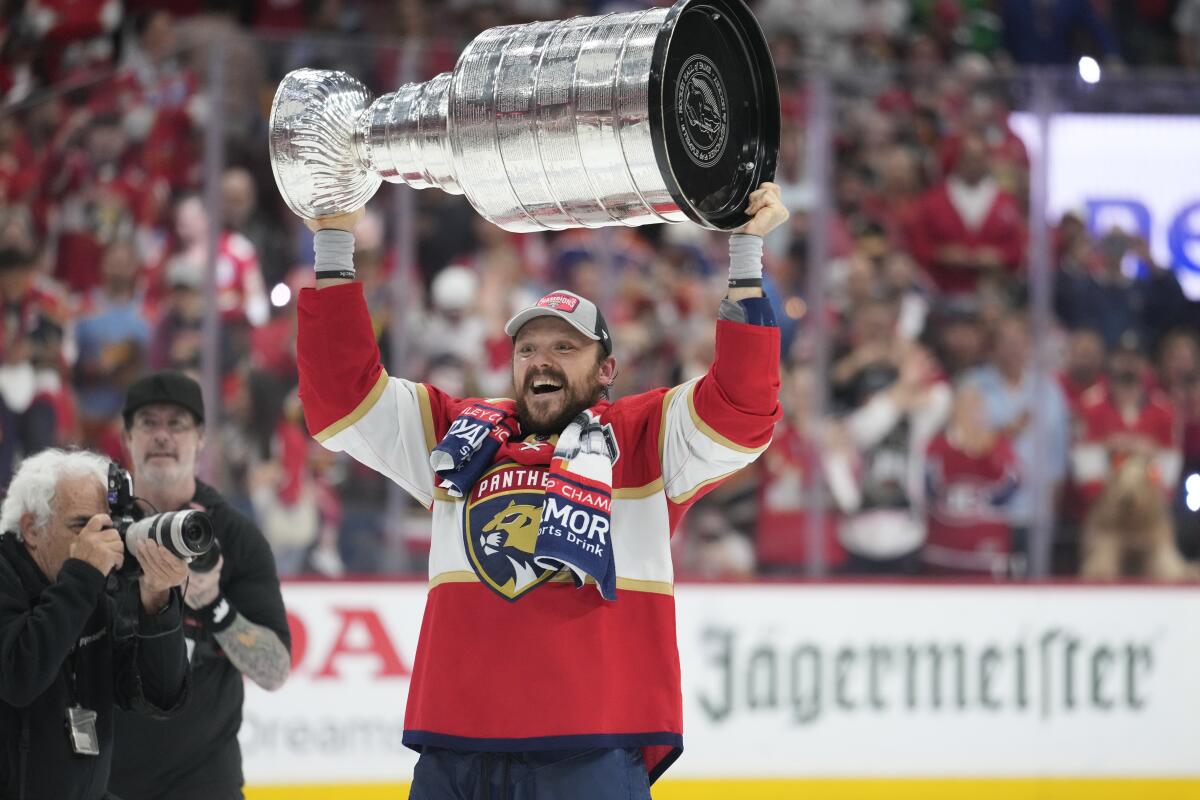 Florida center Sam Reinhart celebrates with the Stanley Cup following the Panthers' Game 7 win.