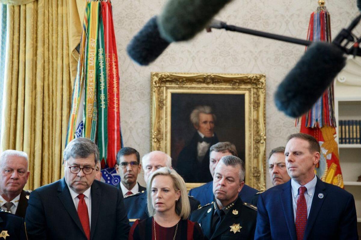 Homeland Security Secretary Kirstjen Nielsen and others listen to President Trump as he vetoes the House resolution striking down his national emergency declaration at the border.