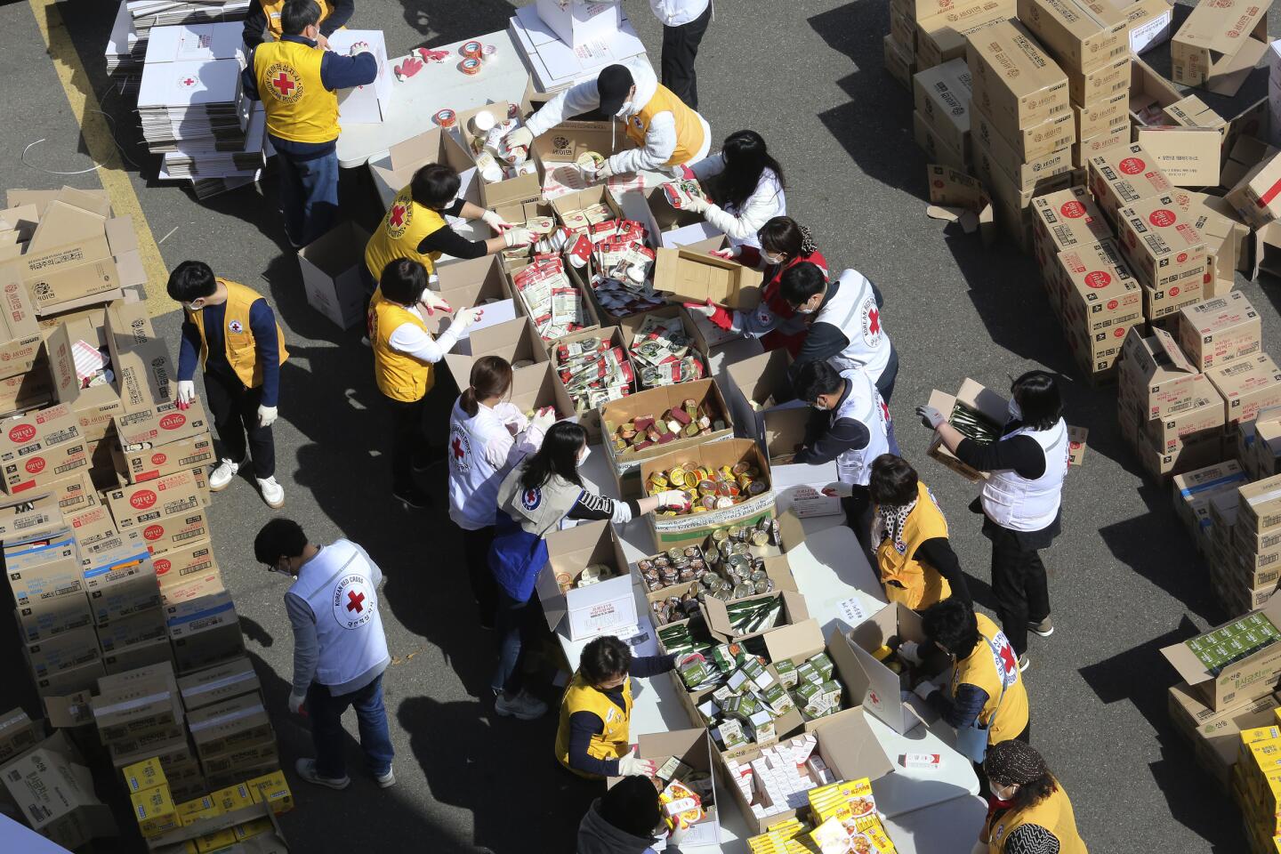 South Korea: Red Cross workers prepare emergency relief kits packed with basic necessities like instant food for delivery to impoverished people experiencing difficulties amid the spread of the new coronavirus.