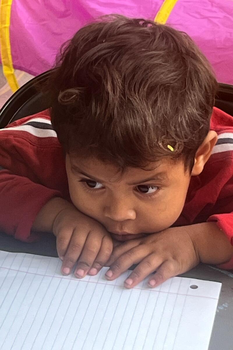 A young child attends class at the Sidewalk School.