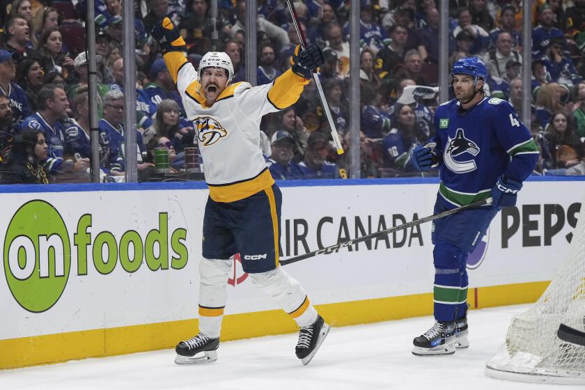 Nashville Predators' Filip Forsberg, left, celebrates his goal, next to Vancouver Canucks' Noah Juulsen during the second period in Game 2 of an NHL hockey Stanley Cup first-round playoff series Tuesday, April 23, 2024, in Vancouver, British Columbia. (Darryl Dyck/The Canadian Press via AP)