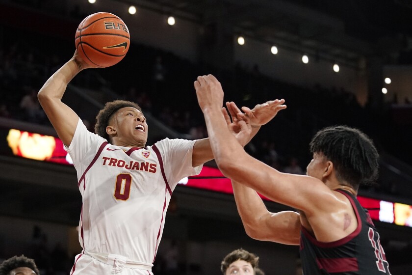 USC guard Boogie Ellis goes up for a dunks attempt as Stanford forward Spencer Jones defends.