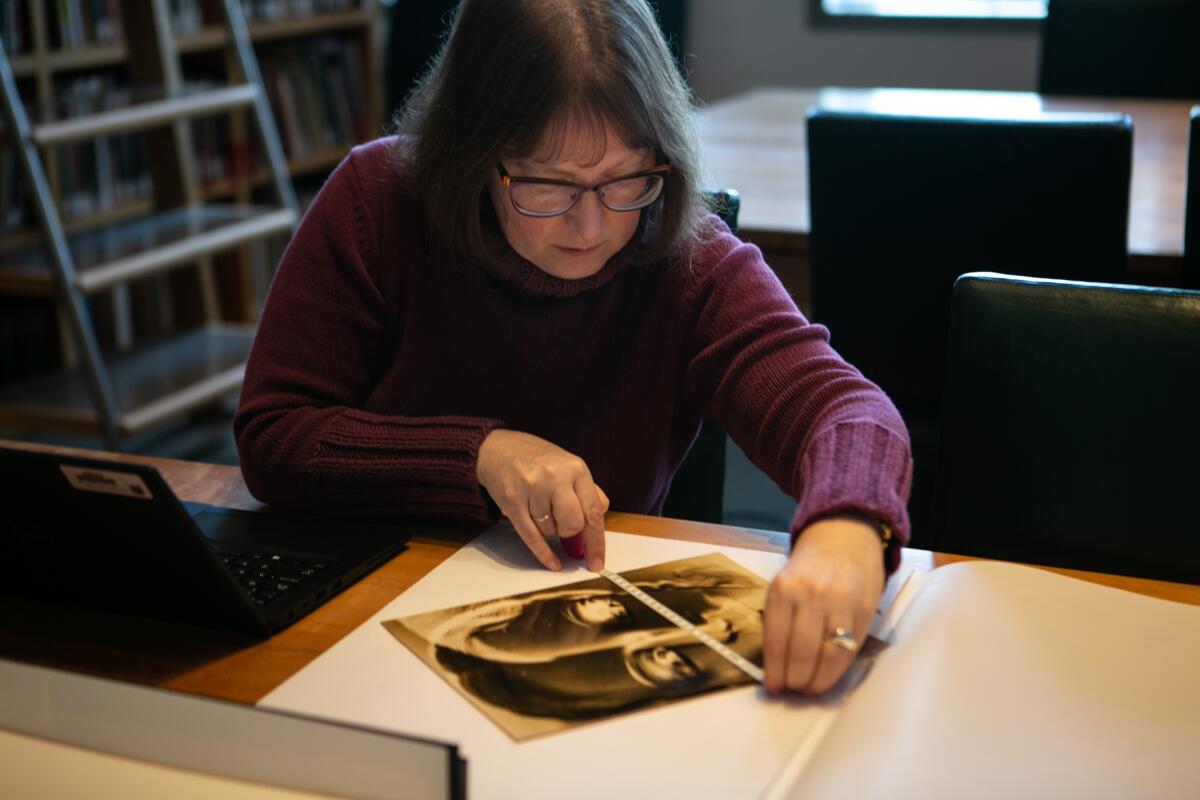 Miriam Katz, collections manager and lead cataloger at the Getty, measures a print. 