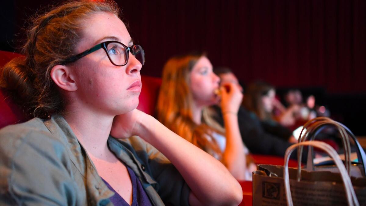 “If we’re gonna be hanging out on the [Third Street] Promenade, we might as well go to a movie,” says Morgan Gerlach, shown watching "Baywatch" in Santa Monica. (Christina House / For The Times)