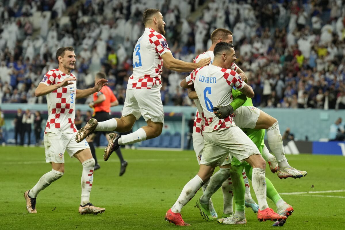 Croatian players celebrate after deafeating Japan during the World Cup round of 16 soccer match between Japan and Croatia at the Al Janoub Stadium in Al Wakrah, Qatar, Monday, Dec. 5, 2022. (AP Photo/Francisco Seco)