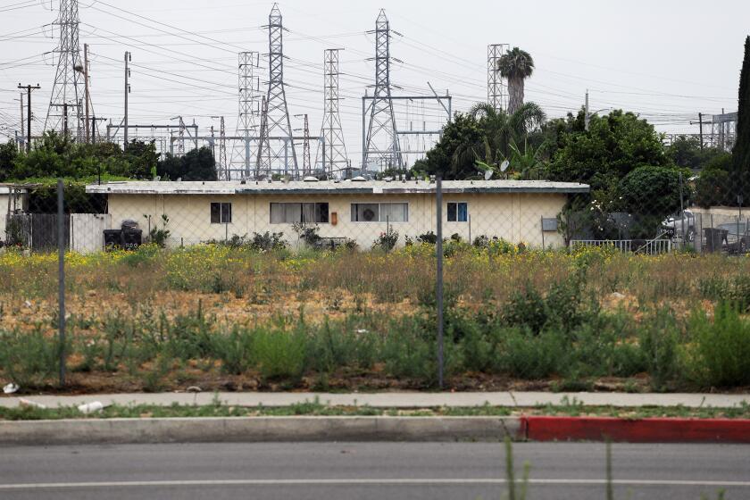 A gated empty lot on Magnolia Avenue in Stanton on Thursday, July 11, 2024. A lawsuit claims that Stanton is violating relocation laws for residents of the Tina-Pacific neighborhood displaced by the city's development plans. (Photo by James Carbone)