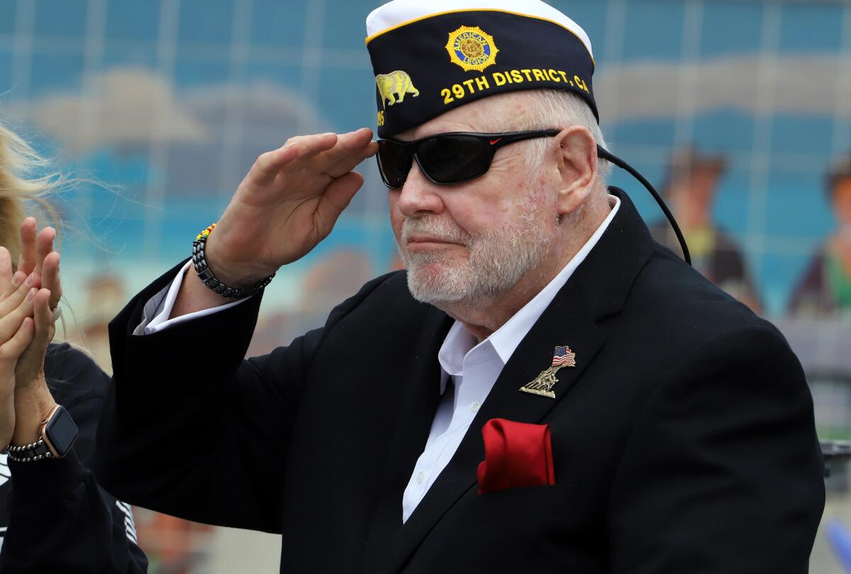 Bernard Thurman, a U.S. Marine who served in three combat tours and is part of American Legion Post 295, stands and salutes.