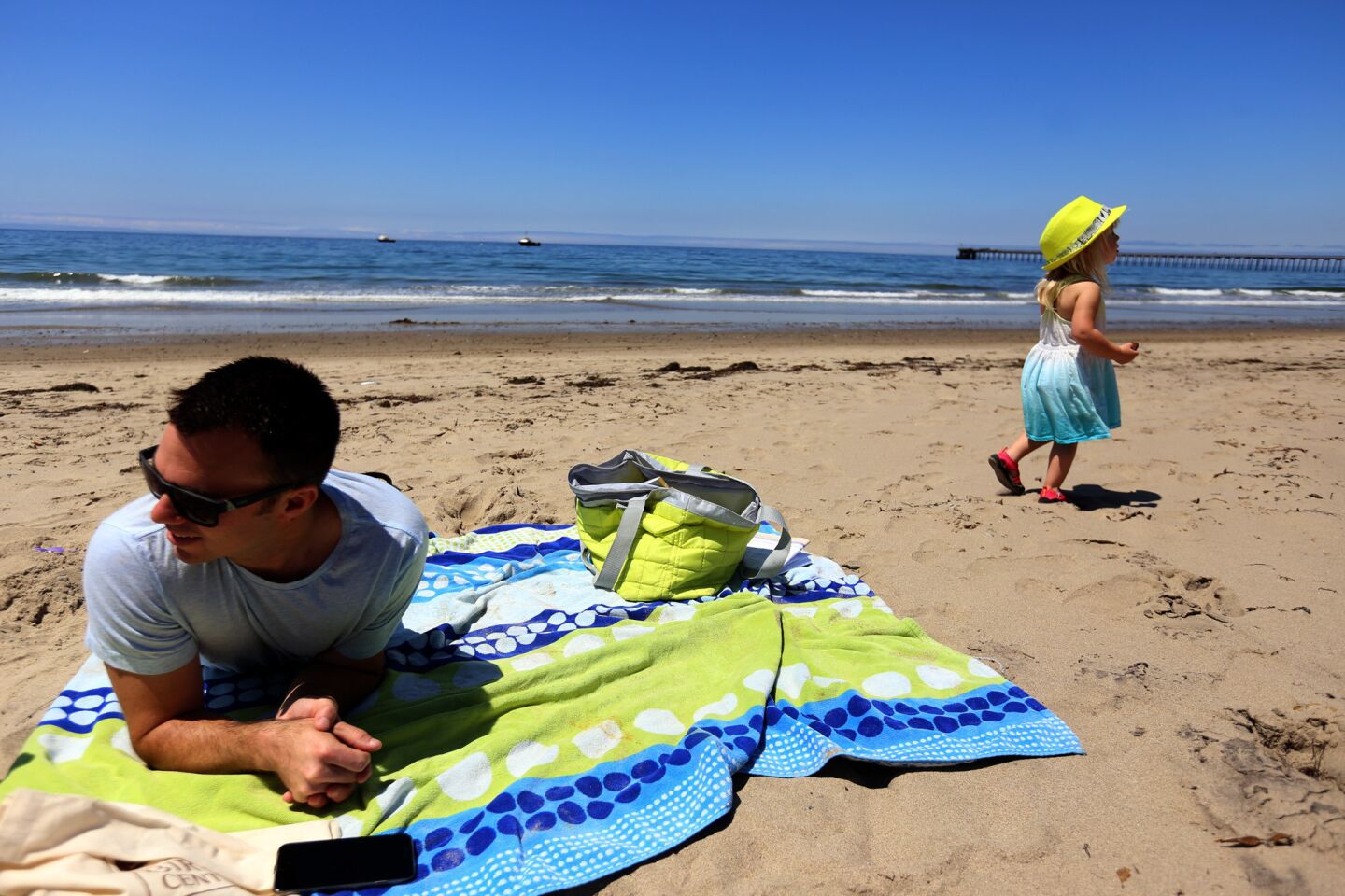 James Daly spends time with his daughter Camryn, 2, at Haskell Beach just south of the area of the oil spill. He noted that there's usually more people on the beach for Memorial Day weekend.