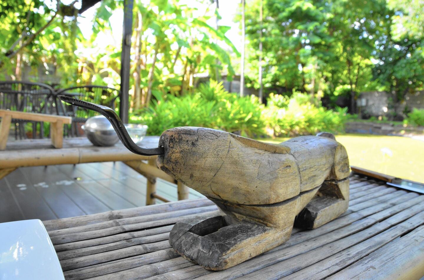This large wooden rabbit is a tool used to dig the flesh out of coconuts.