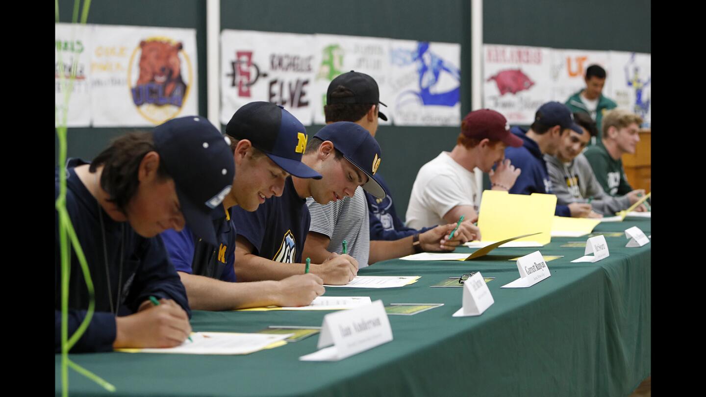 Athletes sign their letter of intent during a signing day ceremony at Edison High on Thursday.