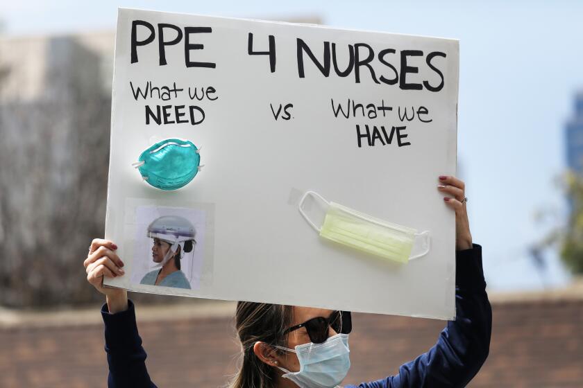 ORANGE, CALIFORNIA - APRIL 03: A nurse holds up a sign to protest the lack of personal protective gear available at UCI Medical Center amid the coronavirus pandemic on April 3, 2020 in Orange, California. Hospitals nationwide are facing shortages of PPE due to the COVID-19 outbreak. (Photo by Mario Tama/Getty Images)