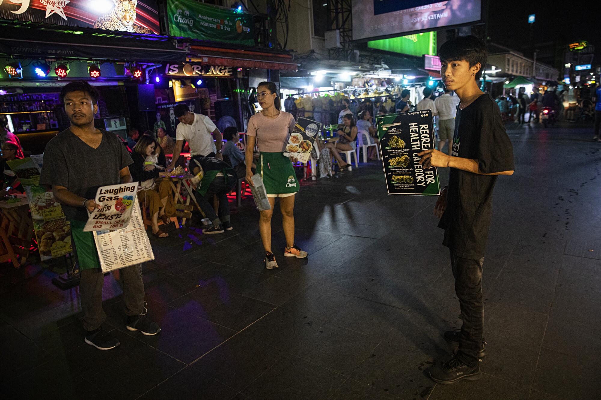 Marijuana vendors wait to approach tourists on Khaosan Road in Bangkok.