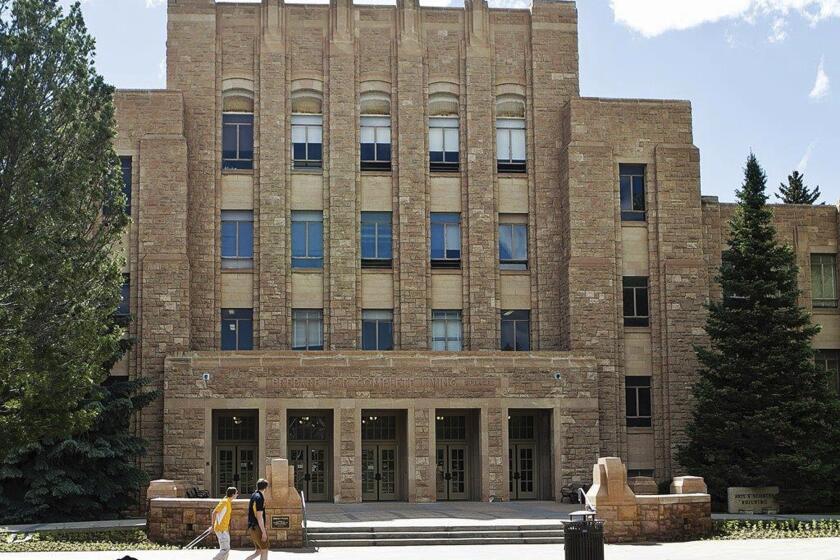 FILE - In this June 14, 2016, file photo, two people walk on the University of Wyoming campus in Laramie, Wyo. The nationwide culture-war battle over the places where transgender people may belong has flared at the University of Wyoming, where a lawsuit filed Monday, March 27, 2023, in U.S. District Court in Cheyenne by seven sorority members, challenges the induction of a transgender woman into their local chapter. (Shannon Broderick/Laramie Boomerang via AP, File)