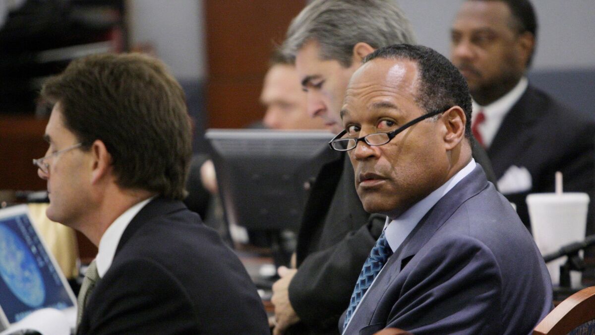 Simpson sits with attorneys Yale Galanter and Gabe Grasso at the start of closing arguments during his robbery trial in Las Vegas, (Jae C. Hong / AFP/Getty Images)