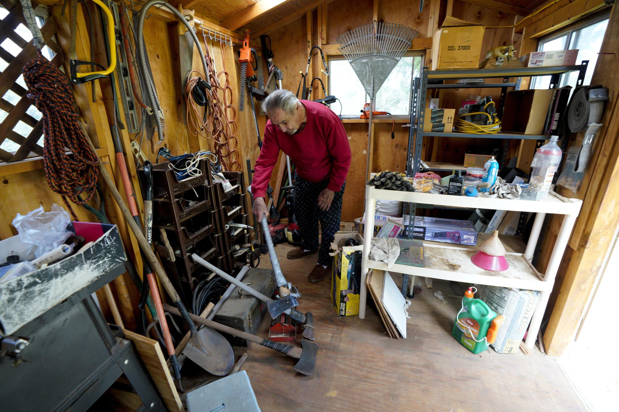 Robert Garant in a shed filled with tools