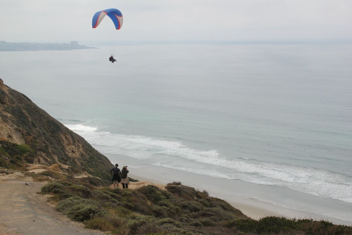 Aerial enthusiasts from the Torrey Pines Gliderport drift over the coast.