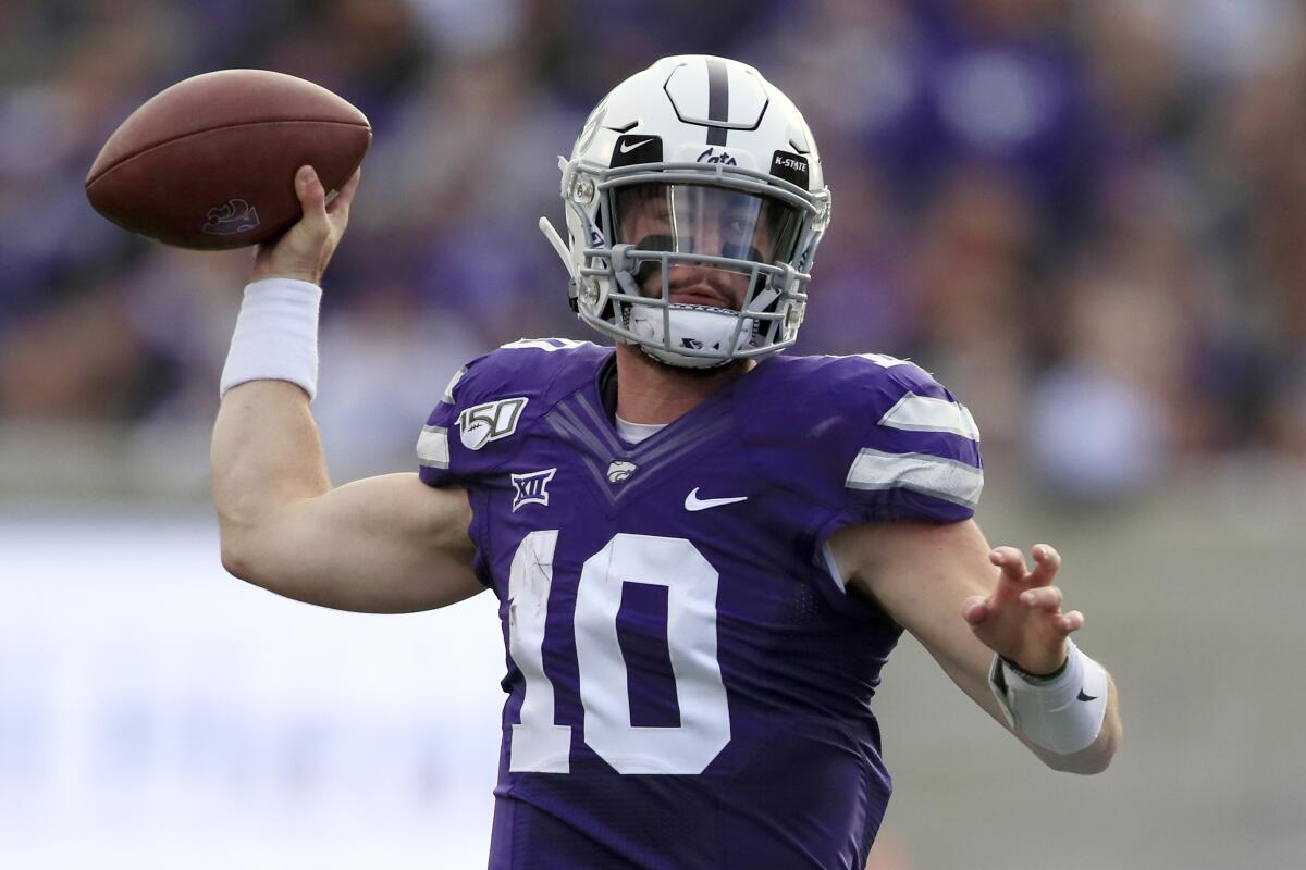 FILE - In this Nov. 16, 2019, file photo, Kansas State quarterback Skylar Thompson (10) passes to a teammate during the first half of an NCAA college football game against West Virginia in Manhattan, Kan. Quarterback Skylar Thompson is back for sixth year at K-State after a season-ending shoulder injury early last season. (AP Photo/Orlin Wagner, File)