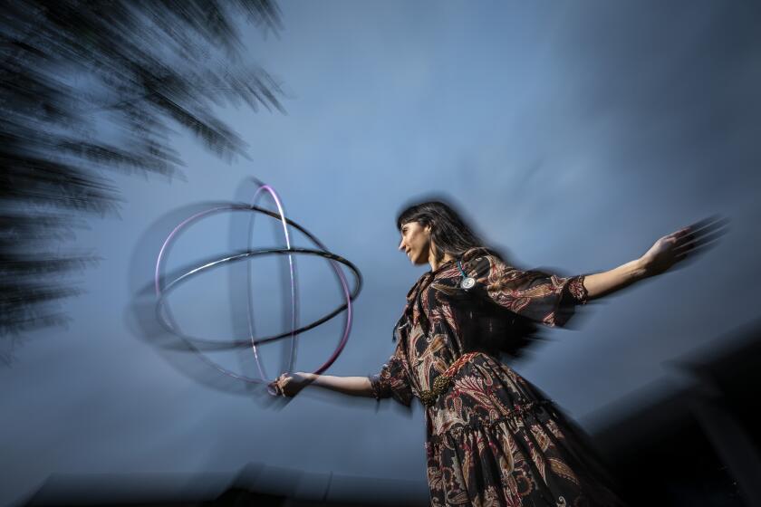 NEWBURY PARK, CA - FEBRUARY 09: G. Sofia Nelson, MD, is a Pulmonologist and in 2020 founded the Lumia Dance Company, focused on prop manipulation and storytelling through dance and is photographed with hoops used in her performances (as well as her stethoscope) in the backyard of her Newbury Park, CA, Tuesday, Feb. 9, 2021. Nelson is with West Coast Pulmonary & Critical Care Physicians and treats COVID-19 patients at St. John’s Regional Hospital in Oxnard and St. John’s Pleasant Valley in Camarillo. (Jay L. Clendenin / Los Angeles Times)