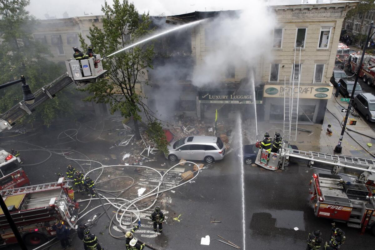 Firefighters work at the scene of an explosion at a three-story building in the Brooklyn borough of New York on Saturday.