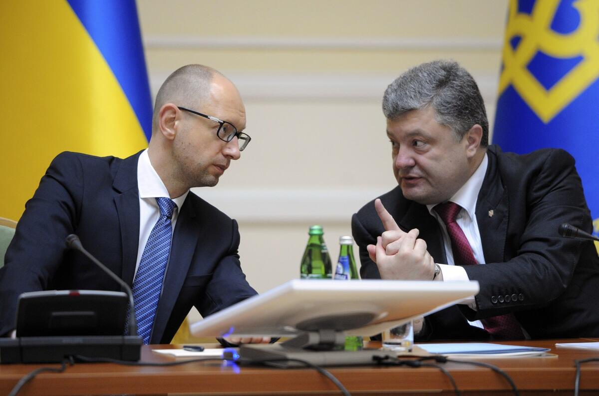 Ukrainian President Petro Poroshenko, right, talks with Prime Minister Arseny Yatsenyuk during a Cabinet meeting in Kiev, Ukraine.