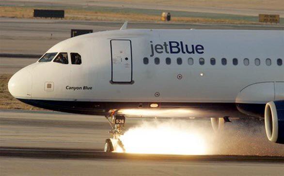 Smoke and sparks fly from a JetBlue aircraft as it makes an emergency landing at Los Angeles International Airport on Sept. 21, 2005.