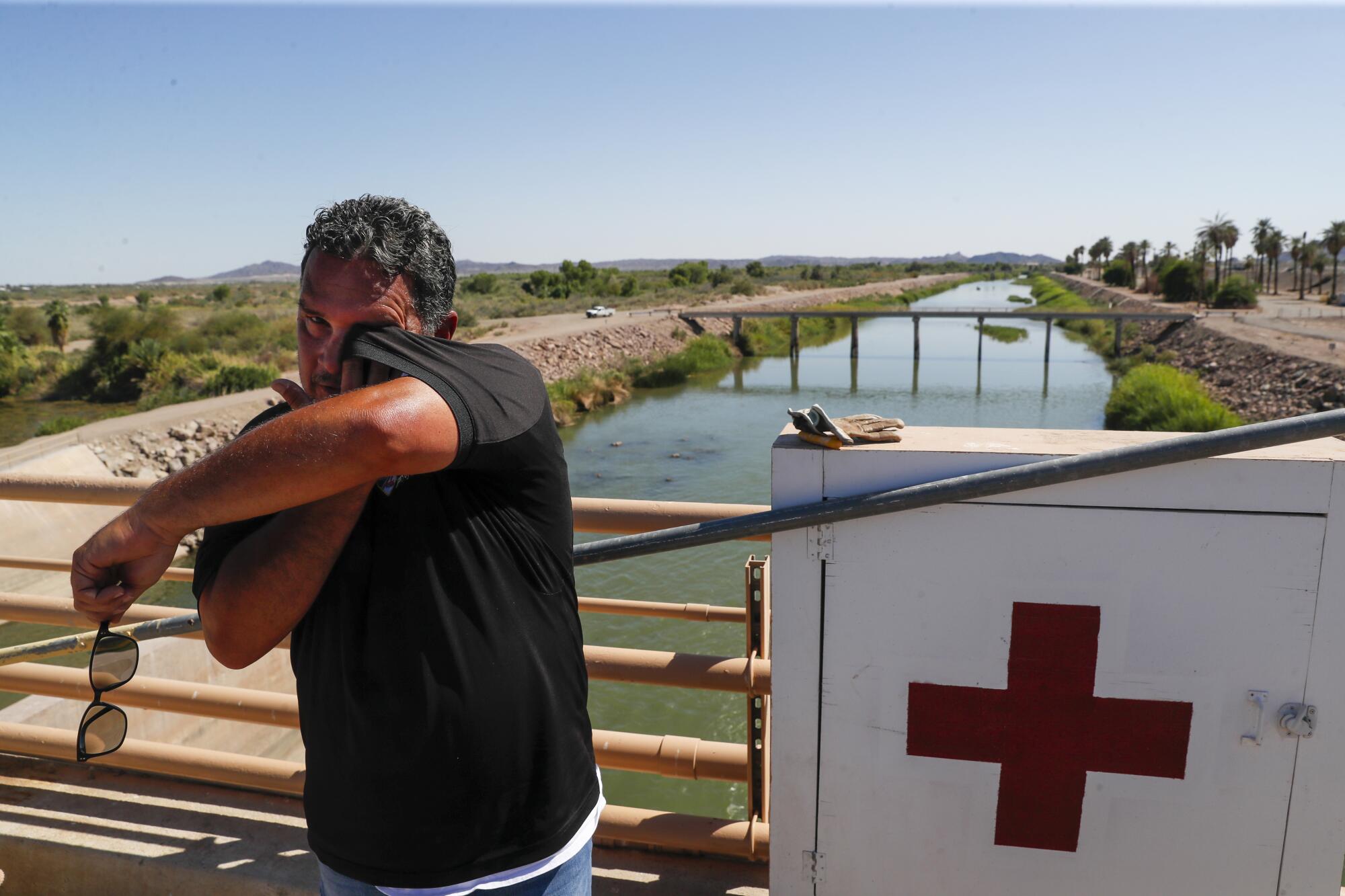 Imperial Irrigation District official David Escobar wipes sweat from his face at Imperial Dam.