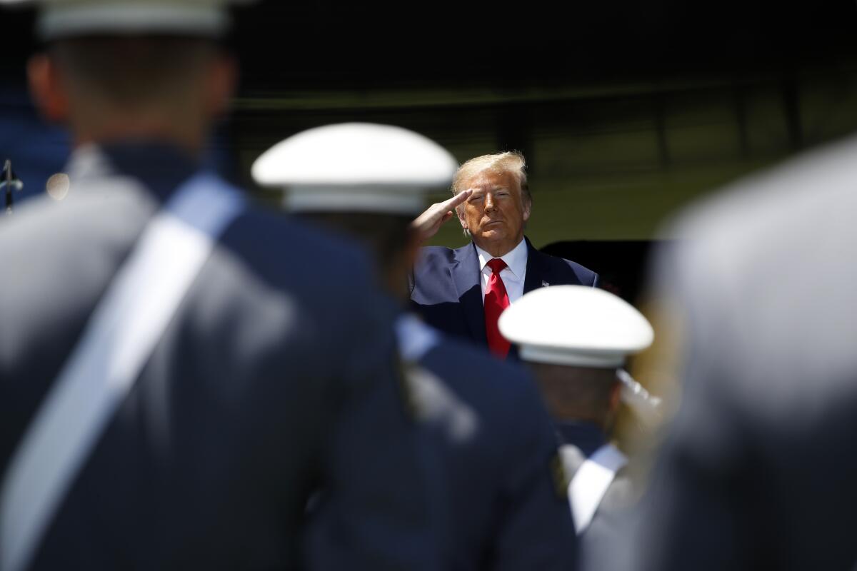 President Donald Trump salutes to the Class of 2020 at the United States Military Academy in West Point, N.Y.