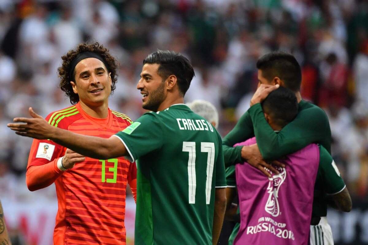 Mexico's goalkeeper Guillermo Ochoa (L) and Mexico's forward Carlos Vela celebrate their 1-0 victory at the end of the Russia 2018 World Cup Group F football match between Germany and Mexico at the Luzhniki Stadium in Moscow on June 17, 2018.