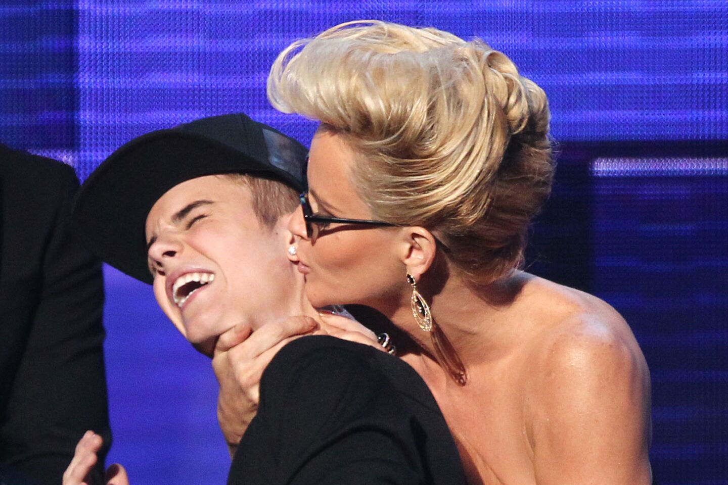 McCarthy plants a kiss on teen heartthrob Justin Bieber at the 2012 American Music Awards. By this time, she had a few relationships that didn't last very long: one with Boston-based sports agent Paul Krepelka and another with Chicago Bears linebacker Brian Urlacher.