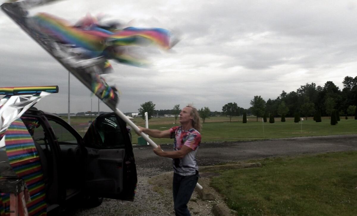 Archer Altstaetter putting the final touches on his DIY pride float.