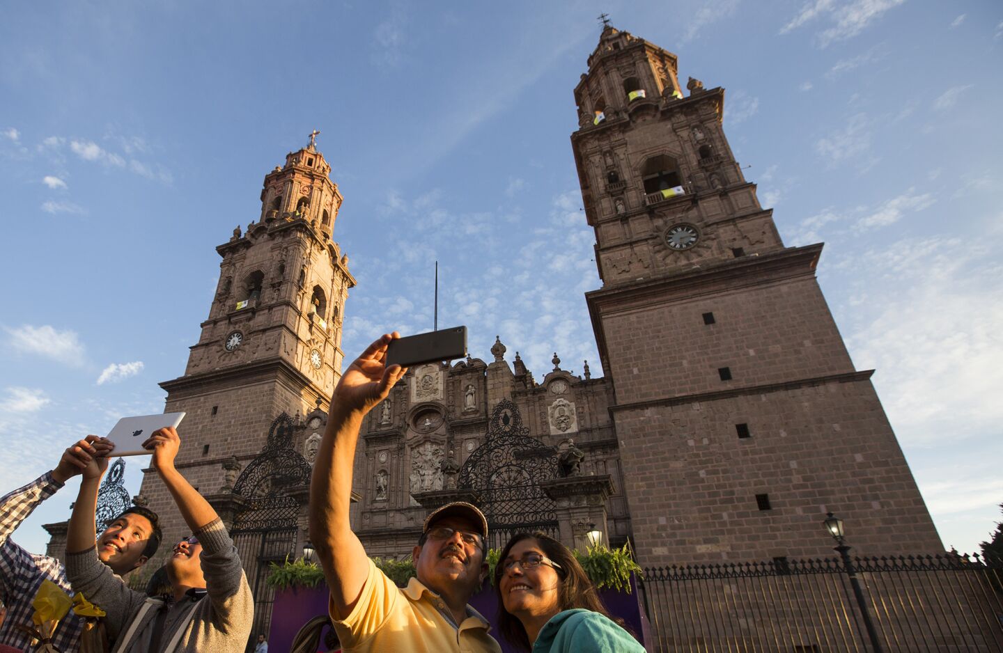 Selfies are taken in front of the Morelia Cathedral as preparations continue for Pope Francis' arrival in Morelia, Michoacan.