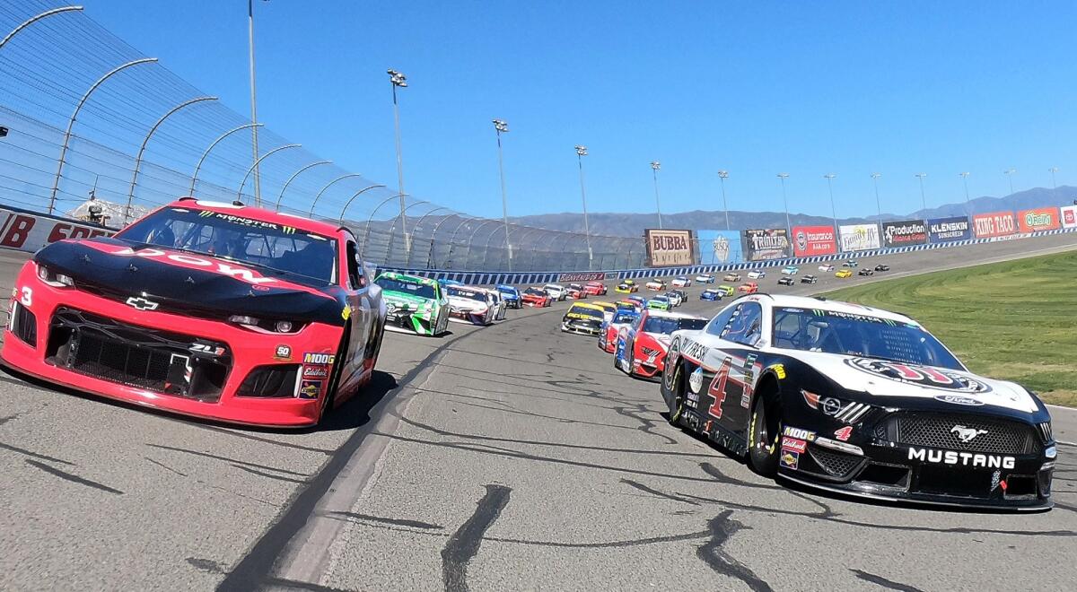 NASCAR driver's Austin Dillon and Kevin Harvick lead the field at the start of the Auto Club 400 on Sunday.