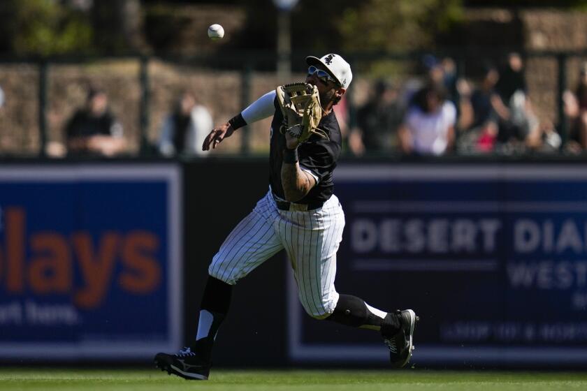 Chicago White Sox right fielder Kevin Pillar catches a fly ball hit by Arizona Diamondbacks' Kyle Garlick during the fifth inning of a spring training baseball game in Phoenix, Monday, March 4, 2024. (AP Photo/Ashley Landis)