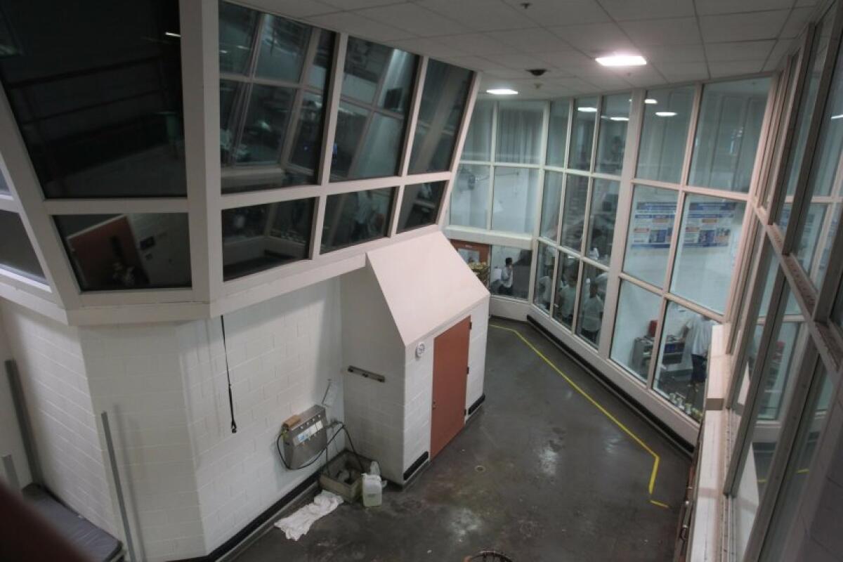 A guard tower with glass windows inside a jail