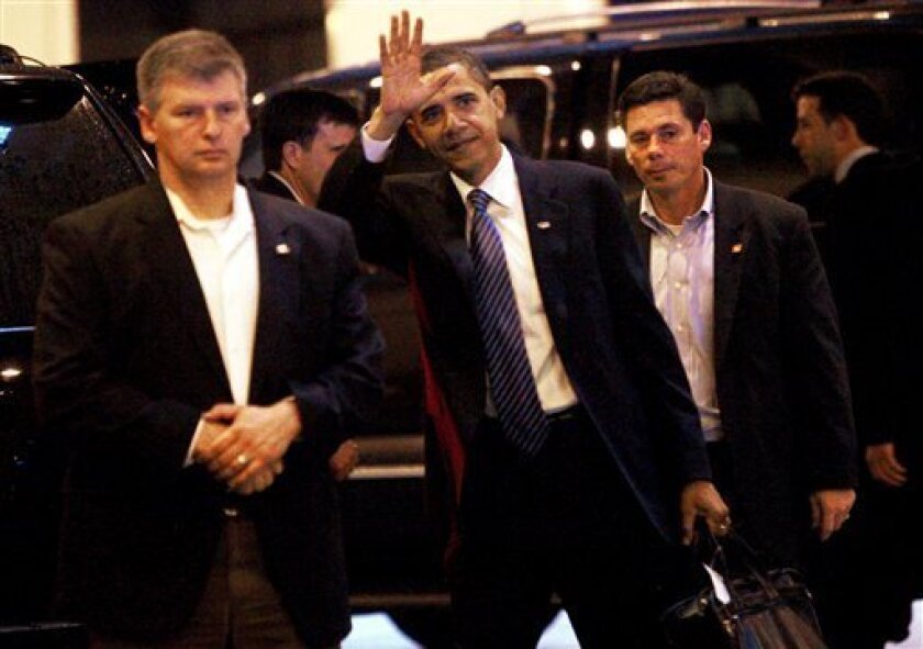 President-elect Barack Obama is accompanied by U.S. Secret Service agents as he arrives for meetings in Chicago, Thursday, Nov. 6, 2008. (AP Photo/Charles Dharapak)