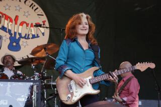 Bonnie Raitt performing on stage