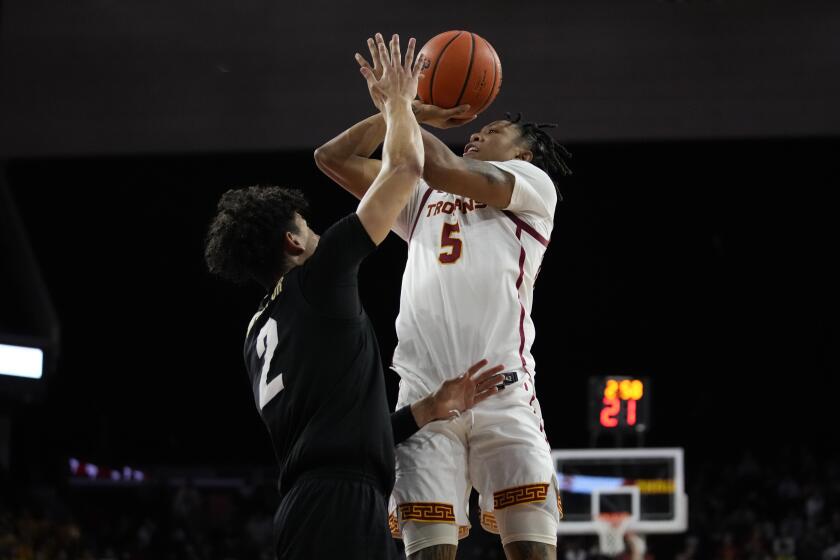 Southern California guard Boogie Ellis (5) shoots against Colorado guard KJ Simpson (2) during the second half of an NCAA college basketball game in Los Angeles, Thursday, Jan. 12, 2023. (AP Photo/Ashley Landis)
