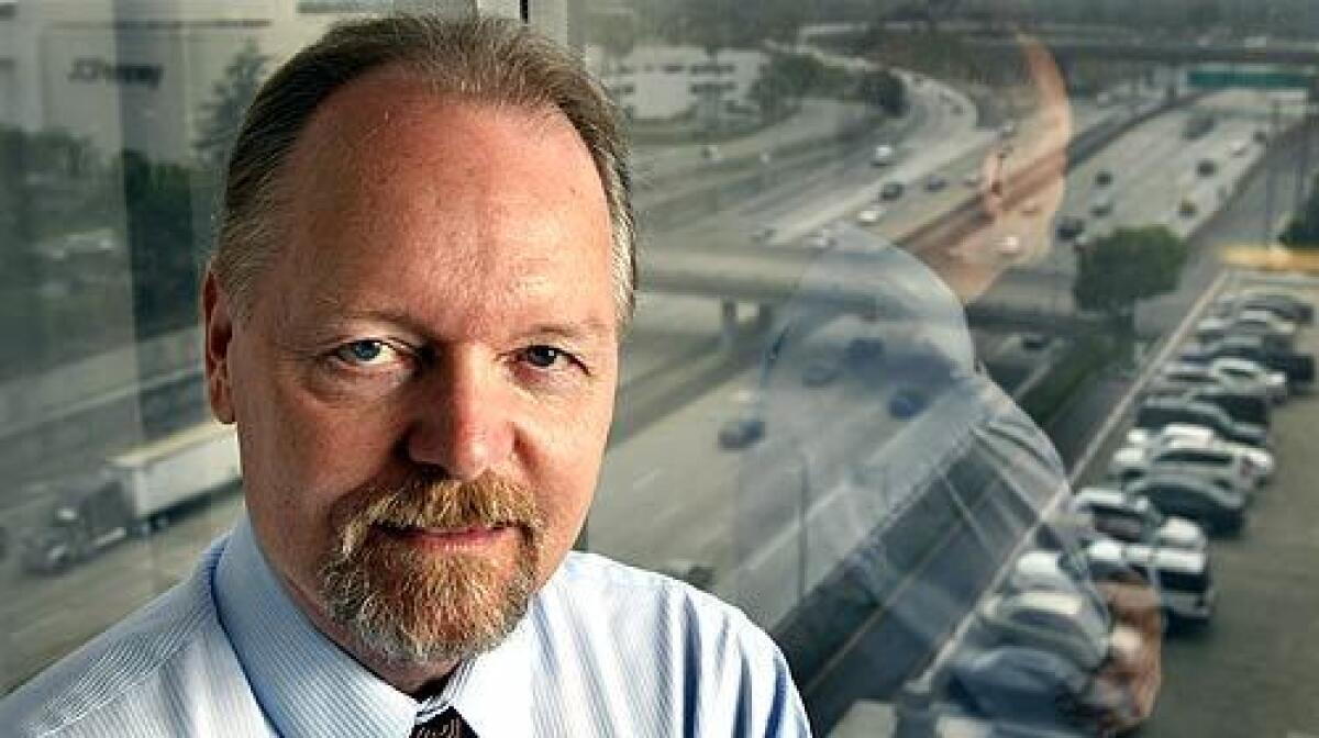 Tom Bogard, director of the highway program for the Orange County Transportation Authority, looks out over the "Orange Crush", where the 22, 57, and 5 freeways converge in Orange County. In the next five years, Bogard and his counterparts in neighboring counties will collect information to coordinate projects to relieve freeway congestion, keeping them spaced apart and done mostly at night, so that commuters can avoid delays.