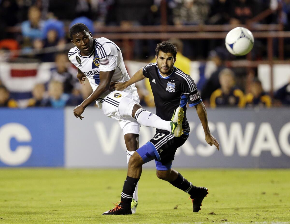 Edson Buddle, left, of the Galaxy shoots past San Jose's Steven Beitashour during the first half of a match on Nov. 7, 2012. The Galaxy on Monday declined contract options on eight players, including Buddle.